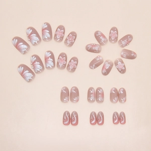 Detail of gradient pearl press-on nails with 3D lily flowers and miniature pearl accents