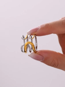 Close-up of a two-tone multi-layer intertwined stainless steel ring on model hand