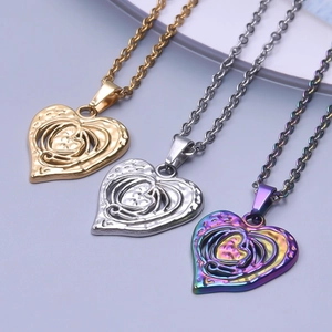 Detail of heart-shaped pendants in gold, silver, and rainbow colors with hollow textures