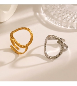 Detailed view of gold and silver open rings with hand-hammered texture and metallic luster