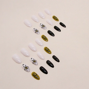 Almond snake print press-on nails set with moon and eye art on black and white tips