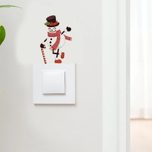 Detail of Christmas snowman wall sticker with red scarf and candy cane above light switch