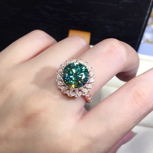 Luxurious green moissanite ring with rose gold band and floral halo setting