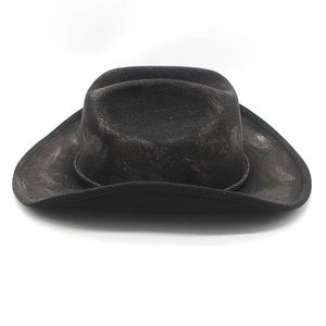 Close-up of distressed vintage western cowboy hat with woven rope band and rugged texture