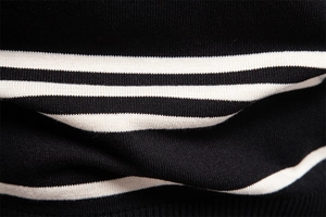 Macro shot of striped knit fabric detail showing premium texture and stitching quality