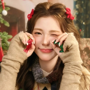 Detail of red velvet bow hair clip paired with beige knit fingerless gloves