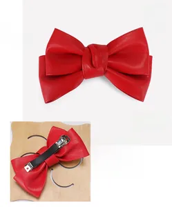 Detail of red PU leather bow hair clip showing front view and back metal spring clip