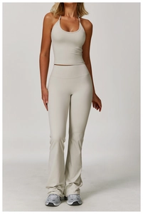 Front view of light beige halter neck sports bra and high-waisted flare yoga pants set