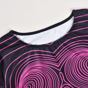 Détail du col rond avec motif cœur ondulé rose sur un haut court noir en maille