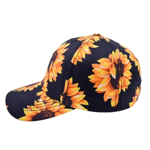 Detail of sunflower print pattern on black twill fabric of the curved brim baseball cap