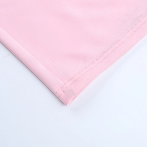Detailed close-up of pink knit fabric showing high-quality stitching and smooth texture