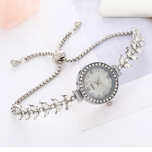 Elegant ladies silver quartz watch with round rhinestone bezel and mother of pearl dial