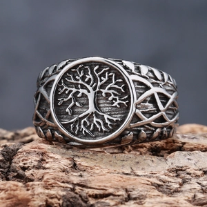 Macro detail of vintage tree of life relief and vine patterns on stainless steel ring