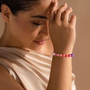 Close-up of pink crystal bead bracelet worn on wrist with natural soft lighting
