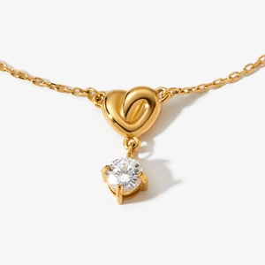 Golden heart knot pendant necklace with round brilliant cut zircon and link chain design