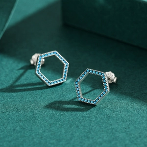 S925 sterling silver hexagonal stud earrings with turquoise inlay on green background