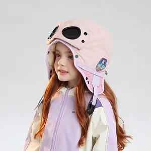 Pink kids aviator hat with goggles and earflaps, warm winter cap with astronaut embroidery