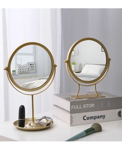 Detail of Nordic round makeup mirrors with gold metal frames and lipstick storage trays