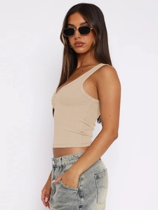 Close-up of beige ribbed knit tank top fabric and slim fit design on a model