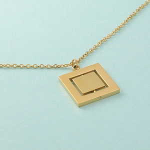 Rotating geometric double square pendant necklace in gold-tone stainless steel finish