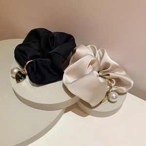 Elegant satin hair scrunchies in black and beige with gold heart charms and pearls