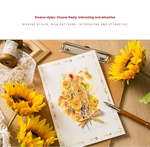 Detailed macro view of handmade greeting card with 3D dried sunflowers and bow decoration