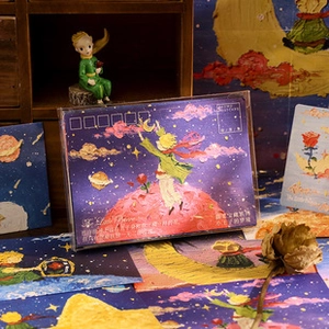 Close-up of The Little Prince vintage postcards with hand-painted oil style and star theme