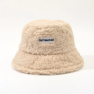 Detailed view of beige lamb wool bucket hat with HaiTalentoM letter embroidery