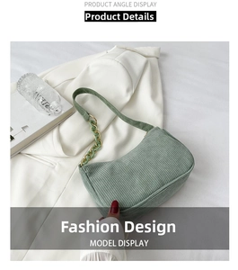 Detail of green corduroy shoulder bag featuring acrylic and gold metal chain strap