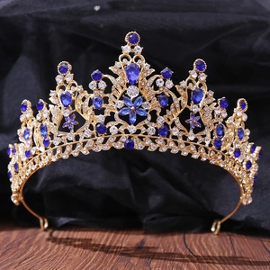 Detailed macro view of gold tiara featuring luxury blue and clear crystal floral patterns