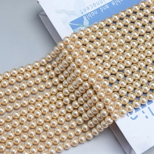 Macro shot of lustrous cream round pearl strands for DIY jewelry making and necklace crafts