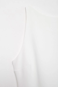 Close-up of high-quality white woven fabric showing detailed stitching and refined texture