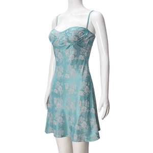 Detail of light blue floral satin slip dress showing smooth fabric and floral print