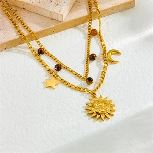 Vintage gold layered necklace with sun moon pendants and tiger eye beads on stone