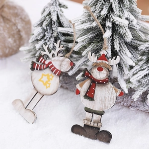 Wooden Christmas reindeer ornaments with red hats and scarves on snowy background