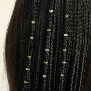 Close-up of gold and silver metallic braided hair rings styled on black hair