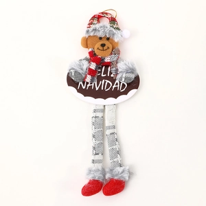 Plush Christmas bear ornament with hanging legs and Feliz Navidad sign for tree decor