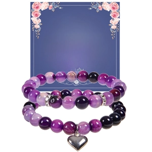 Detail of purple natural stone bead bracelets with heart pendant on gift card