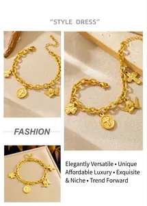 Detail of vintage gold plated chunky chain bracelet with angel and cross charms