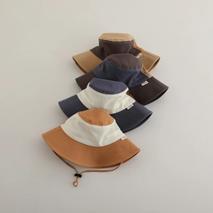 Close-up of four vintage color-block sun hats with wide brims and adjustable wind ropes