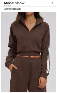 Detail of the high collar zipper and white sleeve stripes on coffee brown tracksuit