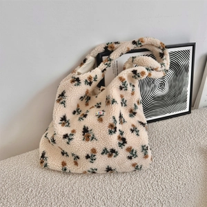 Close-up of plush floral tote bag texture with warm beige lamb wool and flower patterns