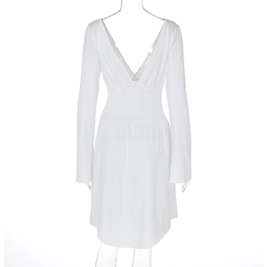 Detailed view of the deep V-neckline and high-waist design on a white long sleeve dress