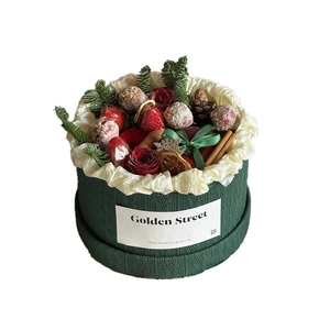 Christmas round gift box with knitted texture, roses, cinnamon sticks and berries