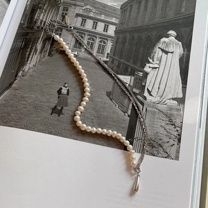925 silver necklace with pearls and water drop pendant on vintage book backdrop