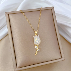 Luxurious gold tulip necklace with pearl finish flower on white silk background