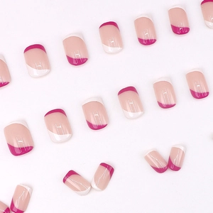 Modern French short press-on nails with white and pink striped tips on nude base