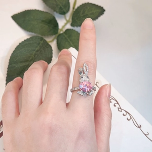 Close-up of rabbit ring with pink gemstone and micro-pave diamonds on model finger