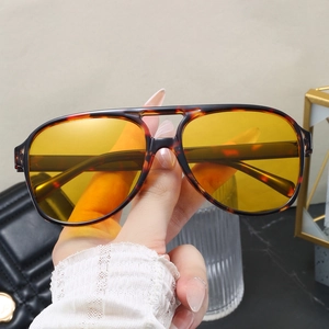 Detail of tortoise frame sunglasses with yellow transparent lenses and double bridge