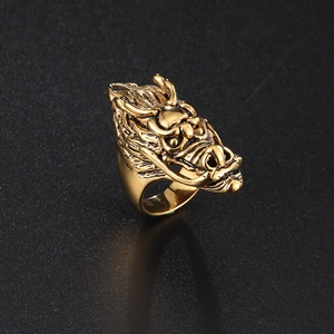 Macro view of vintage gold dragon head ring with detailed scales and steel relief